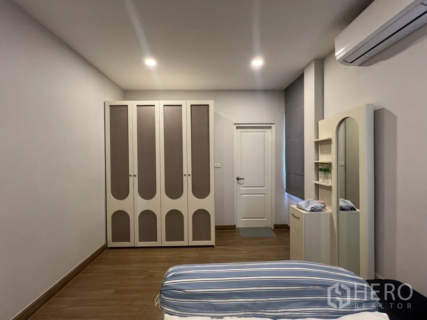 Detached House for rent in Lat Krabang, Bangkok - Bedroom with large wardrobes, dresser, bed frame, and air conditioning.
