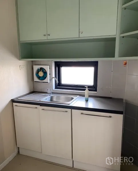 办公空间 出租在Din Daeng, Bangkok - 紧凑茶水间，水槽、黑色台面、白色下柜与绿色吊柜及窗户
