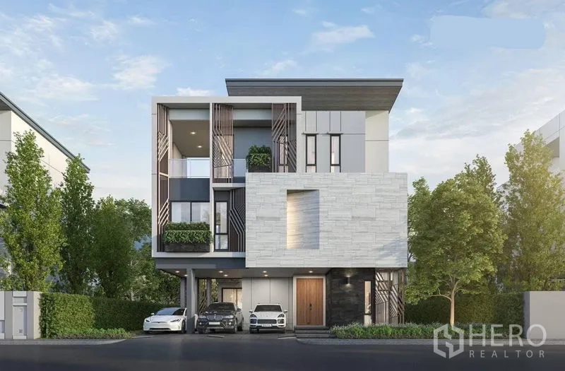 Detached House for rent in Suan Luang, Bangkok - Contemporary three-storey detached house facade with landscaped frontage and covered parking in Suan Luang, Bangkok.
