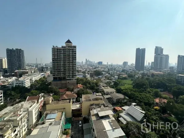 Condominium for rent - High-floor view over the Sathon skyline with towers and green spaces.