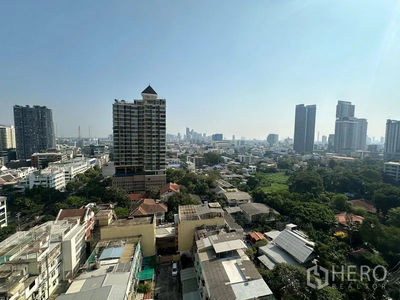 Condominium for rent - High-floor view over the Sathon skyline with towers and green spaces.