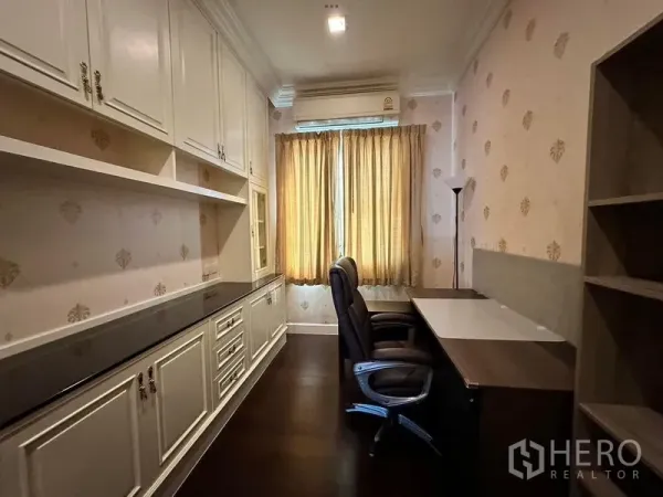 Detached House for rent or sale - Narrow home office with extensive white built-in cabinets, twin desks and curtained window.