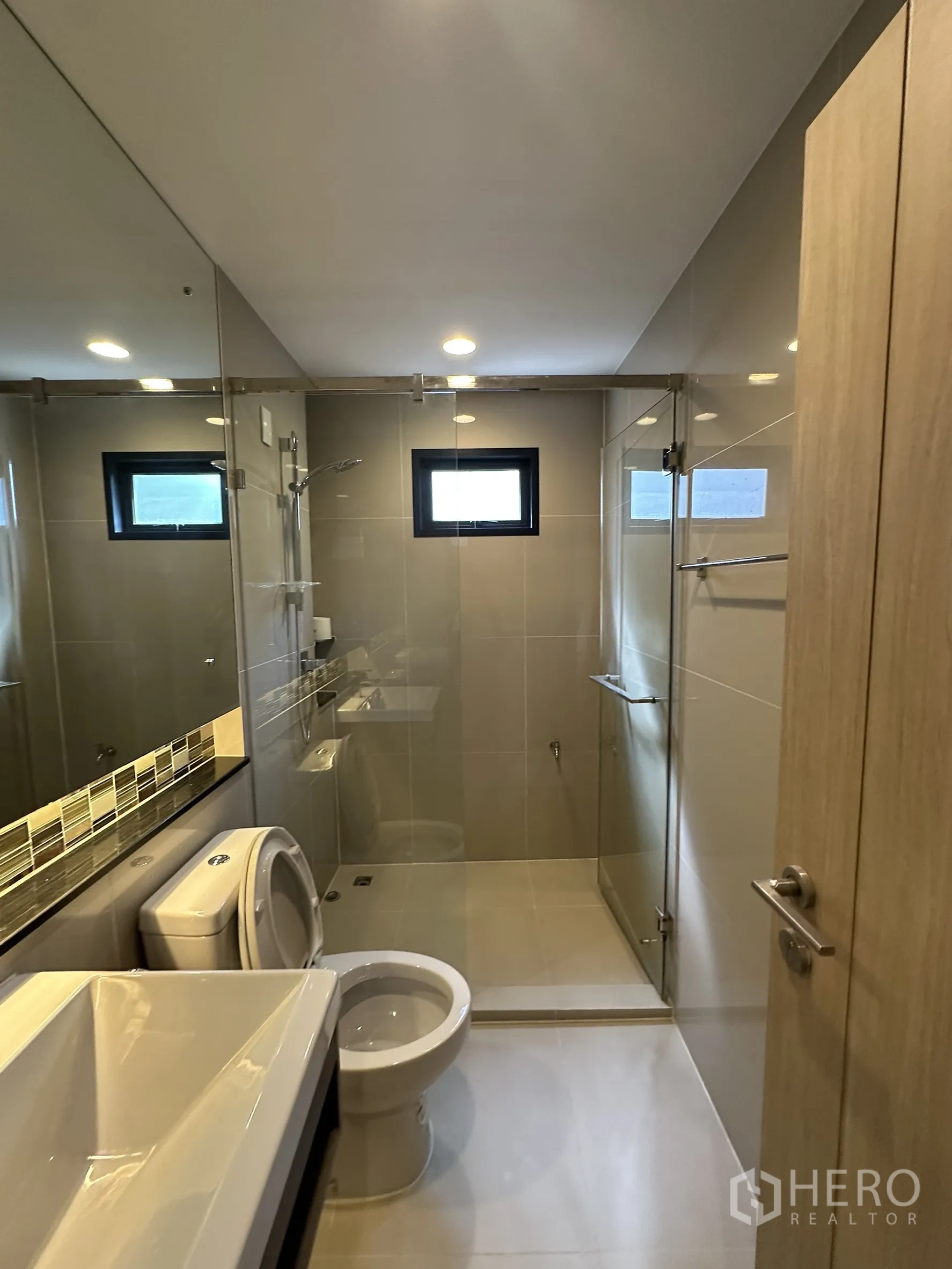 บ้าน ขายในLam Luk Ka, Pathum Thani - ห้องน้ำพร้อมตู้กระจกกั้นอาบน้ำ อ่างล้างหน้า และชักโครก