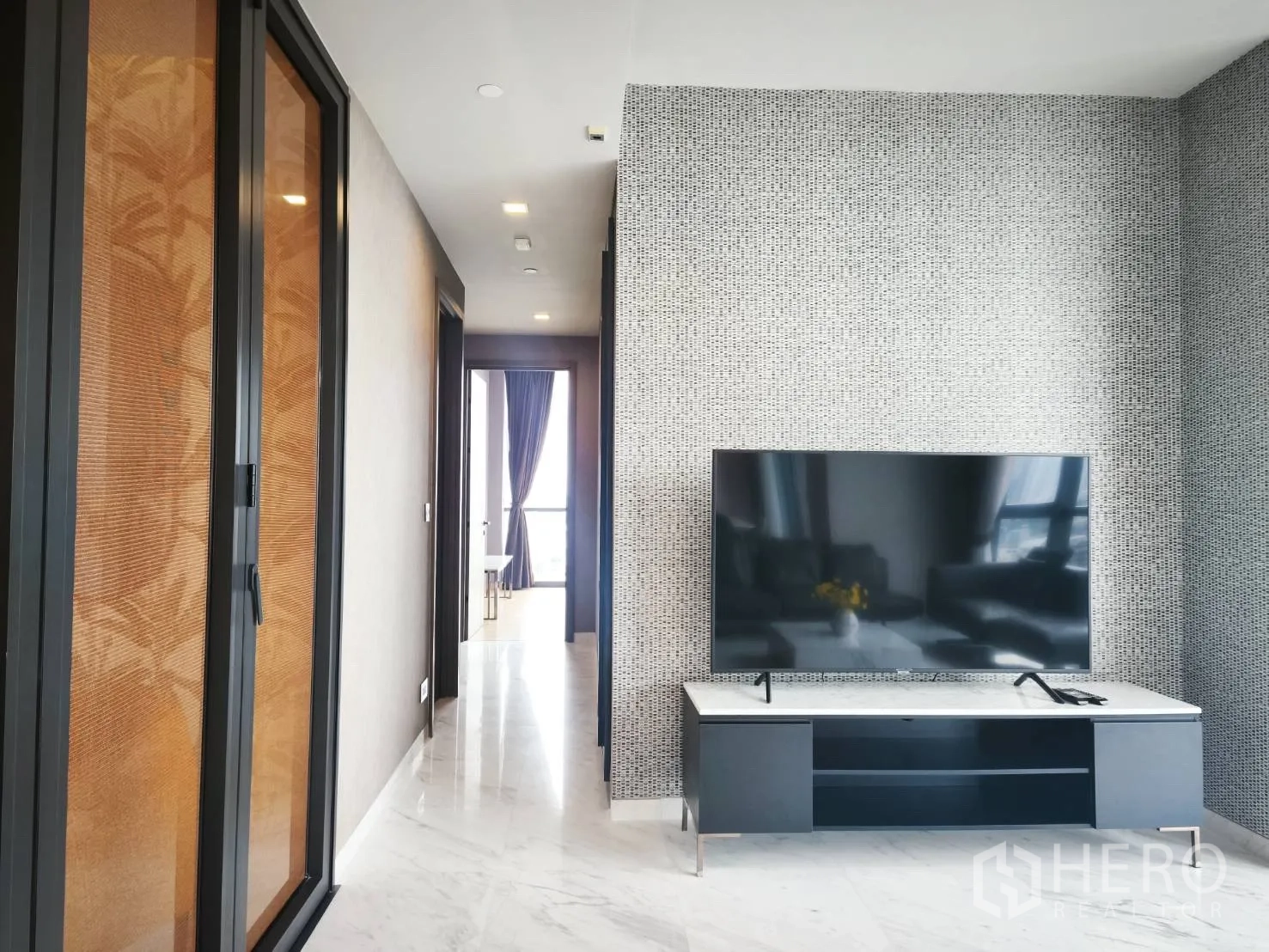 Condominium for rent in Watthana, Bangkok - Hallway with sliding door panels and TV stand.