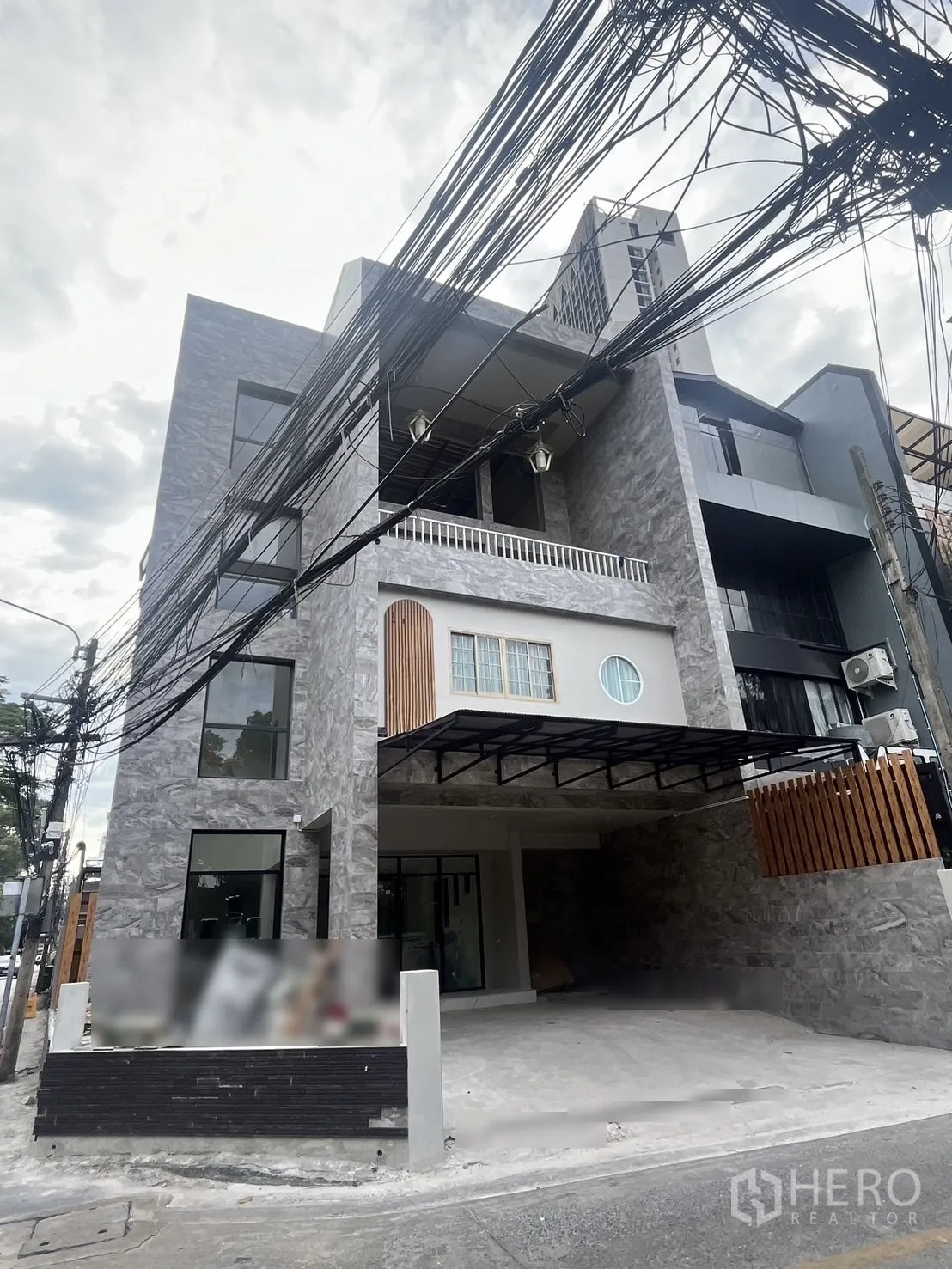 อาคารพาณิชย์ ให้เช่าในWatthana, Bangkok - ภายนอกอาคารพาณิชย์ผนังหินสีเทาหลายชั้น พร้อมกันสาดและกระจกบานใหญ่