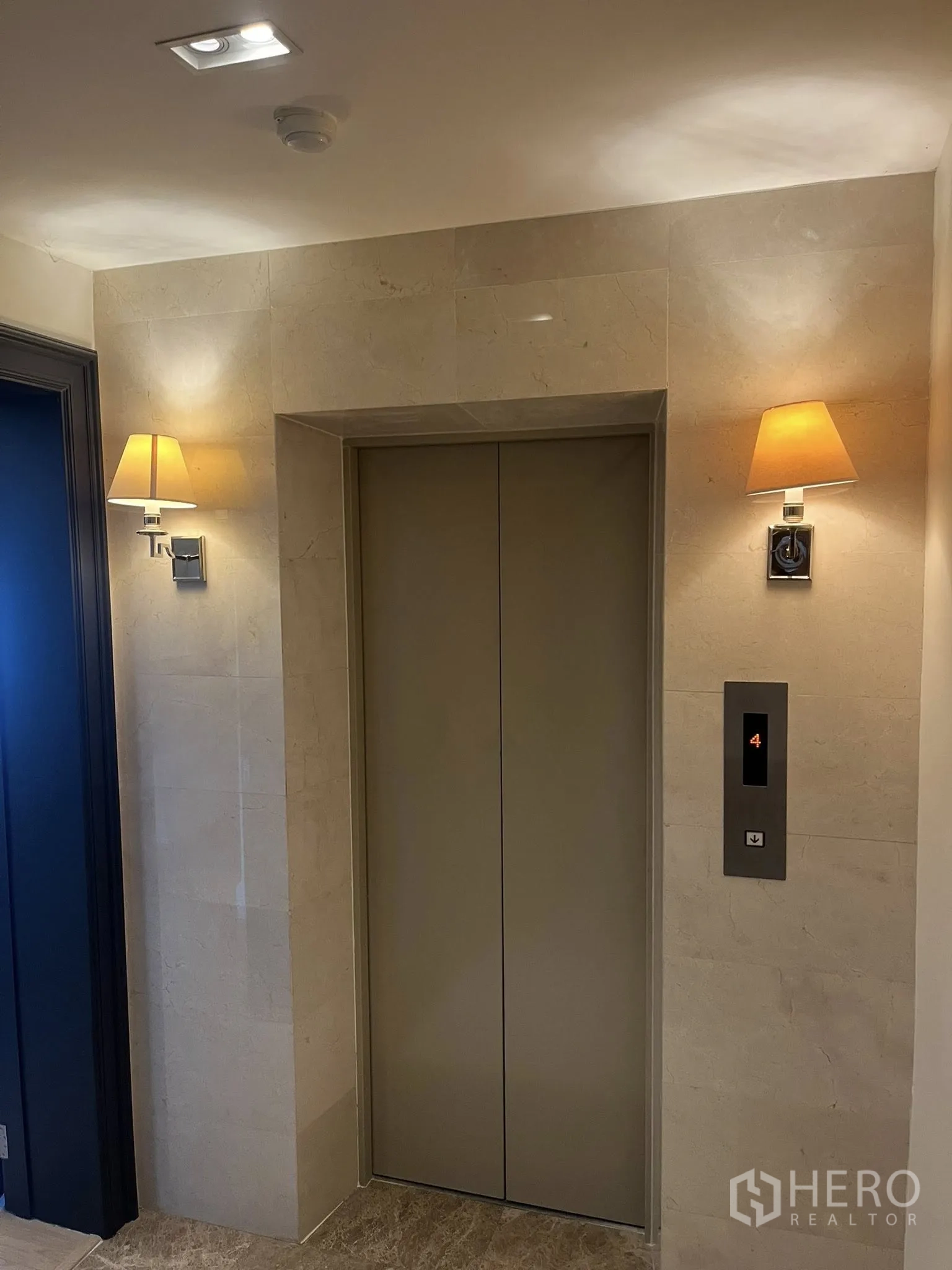 Home Office for rent in Watthana, Bangkok - Private elevator lobby with wall sconces and stone finishes.