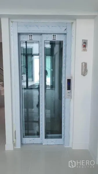 Home Office for rent in Suan Luang, Bangkok - Private in‑building elevator with control panel inside a clean white interior.