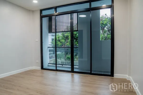 ทาวน์เฮาส์ ขายในWatthana, Bangkok - ห้องนอนพร้อมประตูกระจกบานเลื่อนขนาดใหญ่ เปิดสู่ระเบียงมองเห็นต้นไม้