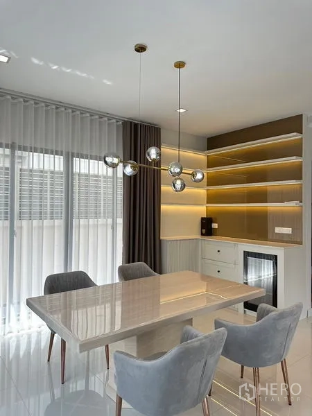 Detached House for rent or sale - Dining space with built-in illuminated shelving and a contemporary chandelier.