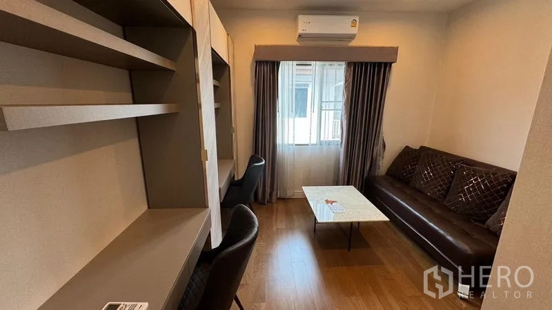 Detached House for rent in Prawet, Bangkok - Home office or study room with shelving, sofa and air conditioner.