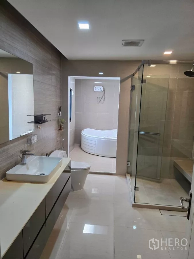 Detached House for rent or sale in Bang Phli, Samut Prakan - Luxury bathroom with long vanity, glass shower, and separate soaking tub.