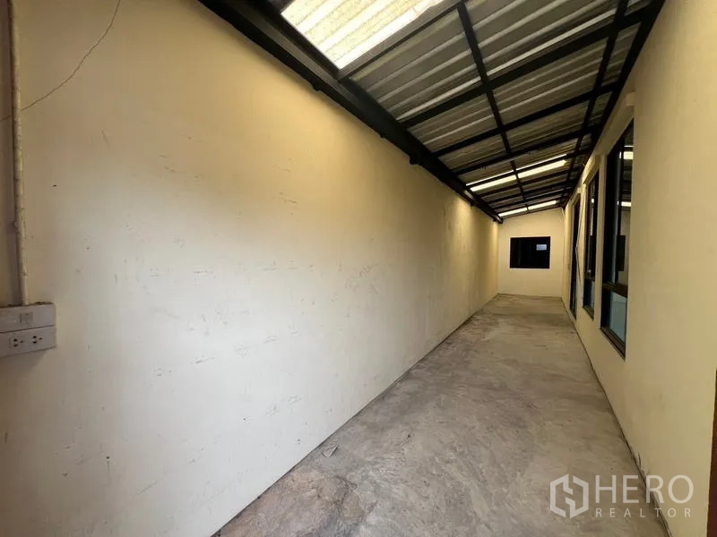 ทาวน์เฮาส์ ให้เช่าหรือขายในKhlong Toei, Bangkok - ทางเดินด้านข้างยาวมีหลังคาเมทัลชีทและหน้าต่าง