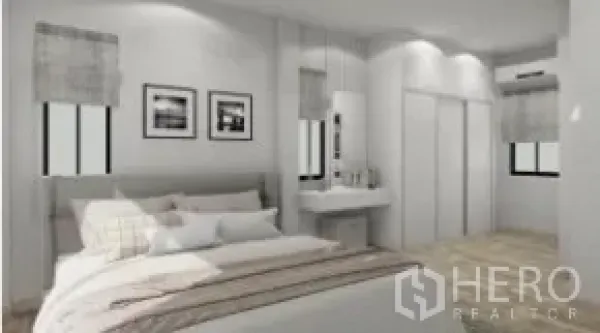 Detached House for rent or sale in Samut Prakan - Spacious master bedroom with bed, wall art, vanity and sliding closet doors.