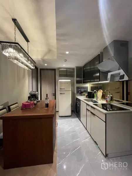 Condominium for rent or sale - Modern kitchen with island, chandelier and retro fridge in Bangkok condo