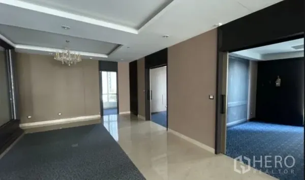 Office Space for rent - Partitioned offices with sliding doors, recessed lighting, and a mix of carpet and tile flooring.