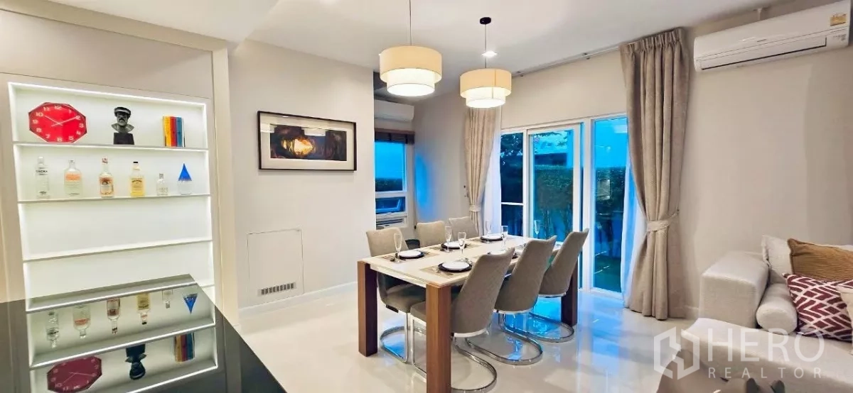 Detached House for rent in Samut Prakan - Open-plan dining and lounge with pendant lights and access to the garden.