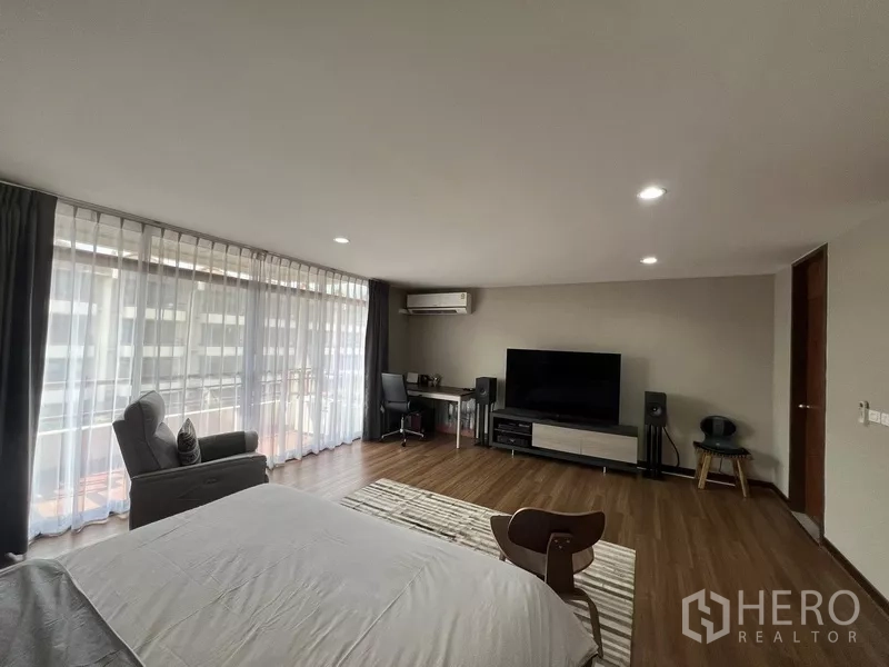 ทาวน์เฮาส์ ให้เช่าหรือขายในSuan Luang, Bangkok - ห้องนอนกว้าง มีทีวี โต๊ะทำงาน หน้าต่างเต็มผนังเชื่อมระเบียง