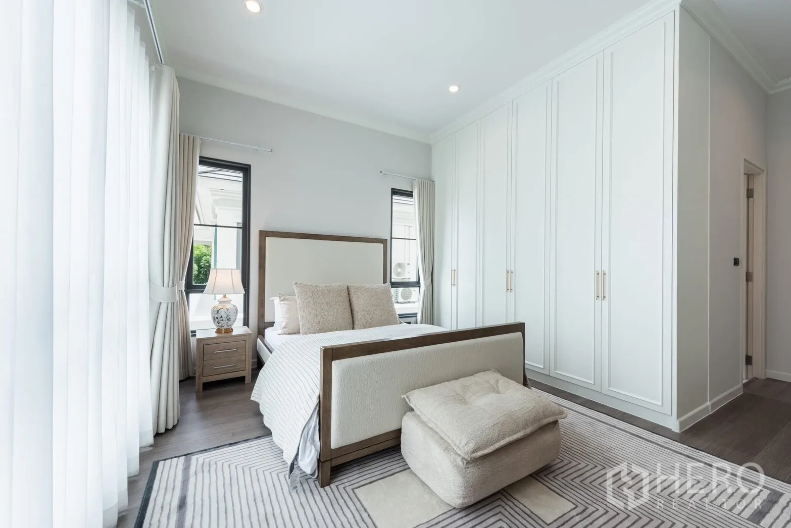 Detached House for rent or sale in Bang Phli, Samut Prakan - Bright bedroom with upholstered bed, full-height wardrobes, and sheer curtains.