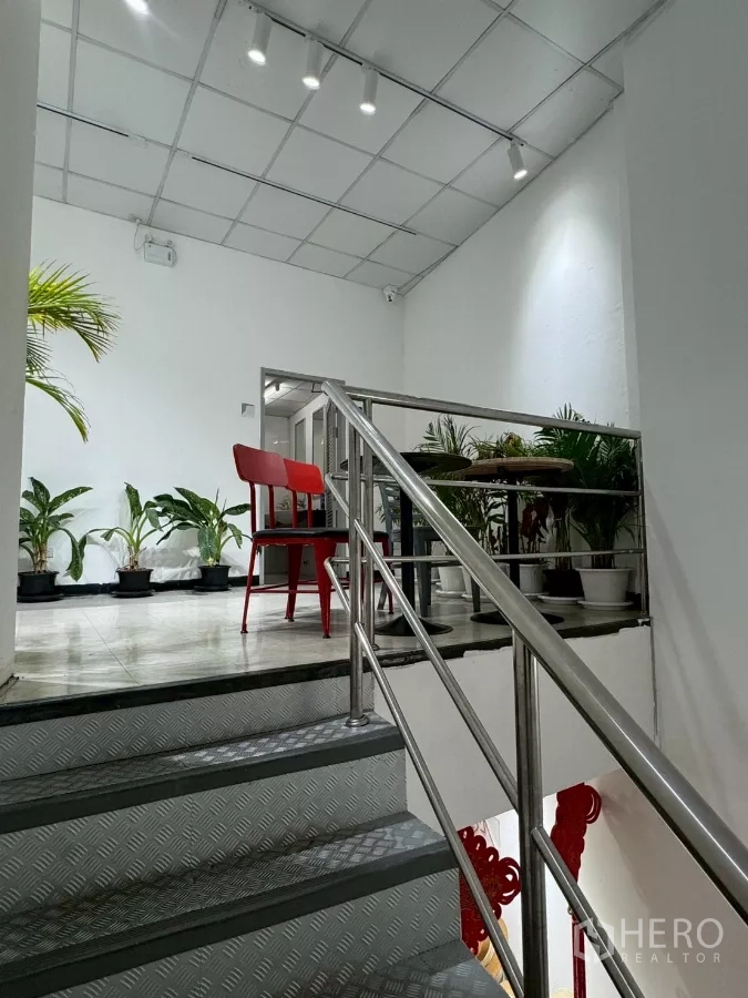 Shophouse for rent in Samphanthawong, Bangkok - Metal staircase with railings leading to upper floor lounge area.