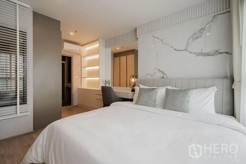 Condominium for rent - Bedroom view showing bed, study desk, wardrobe and warm ambient lighting.