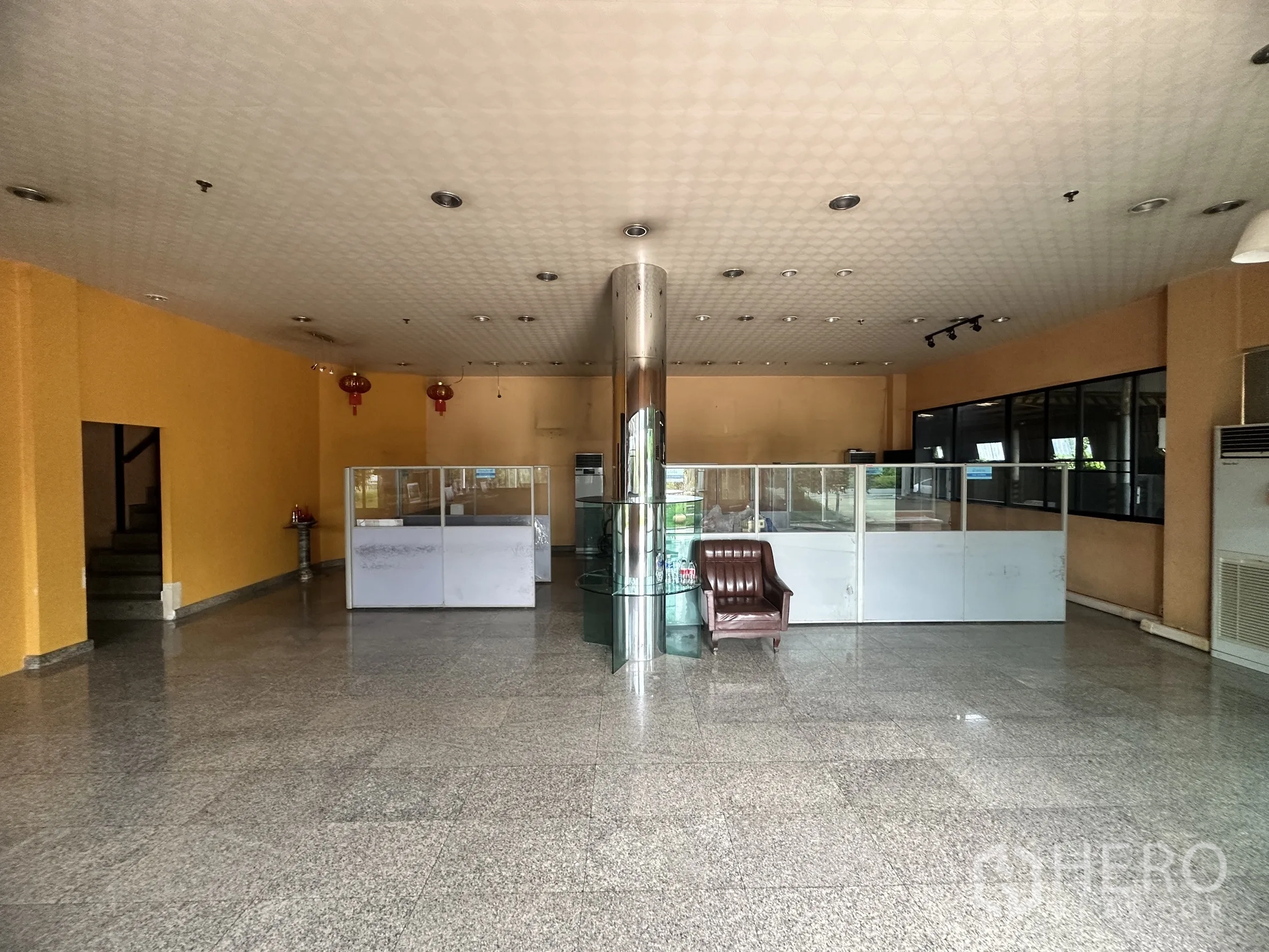 Factory for sale in Bang Bua Thong, Nonthaburi - Reception area with seating, partitioned workstations, and stair access.