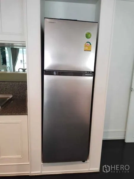 Condominium for rent in Sathon, Bangkok - Stainless-steel refrigerator recessed neatly into built-in cabinetry.