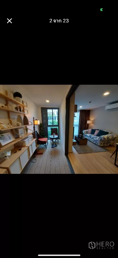 Condominium for rent in Watthana, Bangkok - Phone screenshot showing sunroom and living room divided by a sliding door.