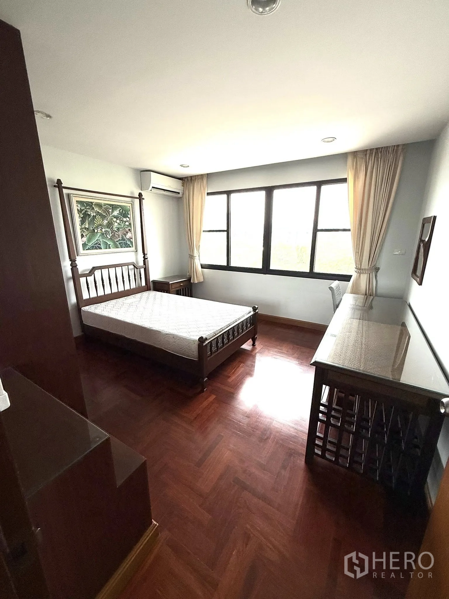 Condominium for rent in Sathon, Bangkok - Bright bedroom corner with bed, desk and double windows.
