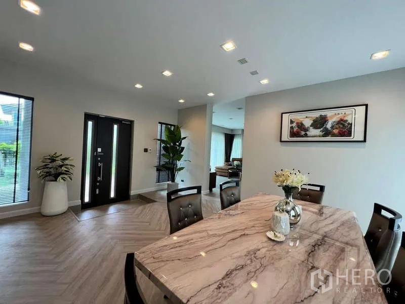 บ้าน ให้เช่าหรือขายในLat Krabang, Bangkok - ห้องทานอาหารแบบโอเพ่น ใกล้ประตูหลัก พร้อมหน้าต่างบานยาวและต้นไม้กระถาง