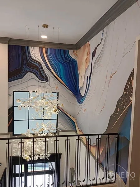 Detached House for rent or sale in Saphan Sung, Bangkok - Staircase landing with abstract mural and a modern pendant chandelier.