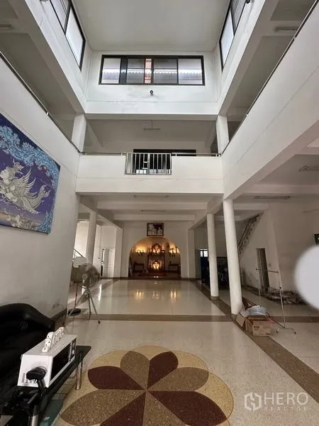 Home Office for sale in Phra Pradaeng, Samut Prakan - Upward view through a multi-storey atrium with windows bringing in light.