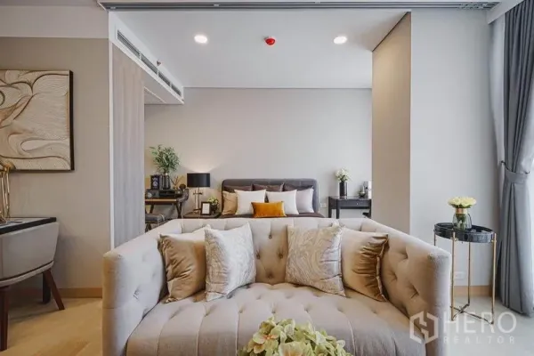 คอนโด ขายในKhlong Toei, Bangkok - มุมพักผ่อนอบอุ่น โซฟาสีครีมวางหน้าหัวเตียง แสงไฟโทนอุ่น และฉากกั้นเลื่อน