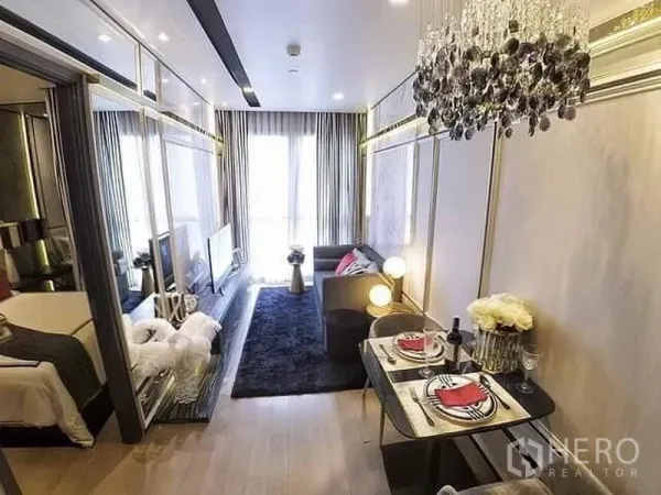 Condominium for rent or sale in Watthana, Bangkok - Open-plan living and dining area with chandelier, floor-to-ceiling windows, and bedroom behind sliding glass.