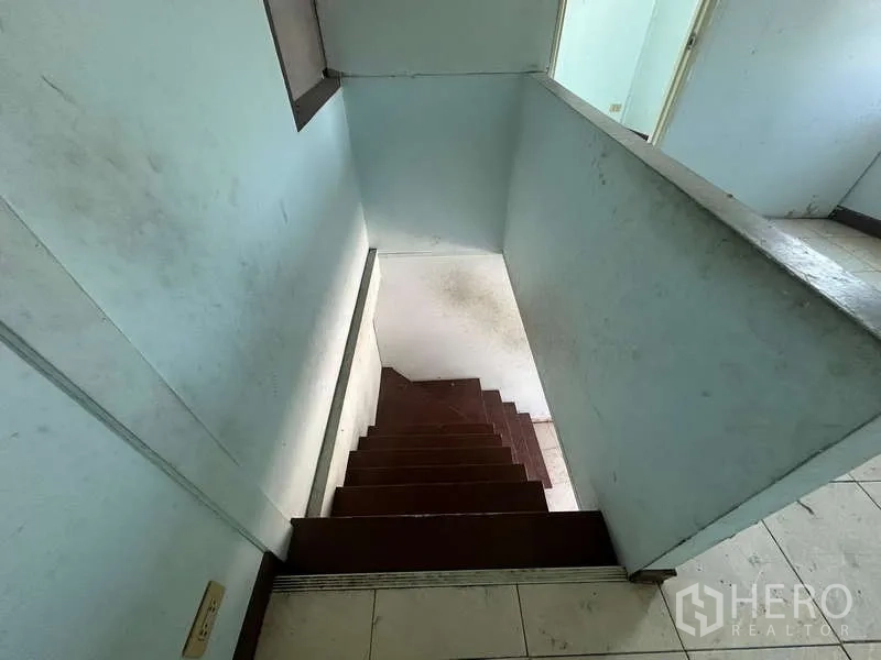 Warehouse for rent in Suan Luang, Bangkok - View down the staircase from the upper floor to the ground level.