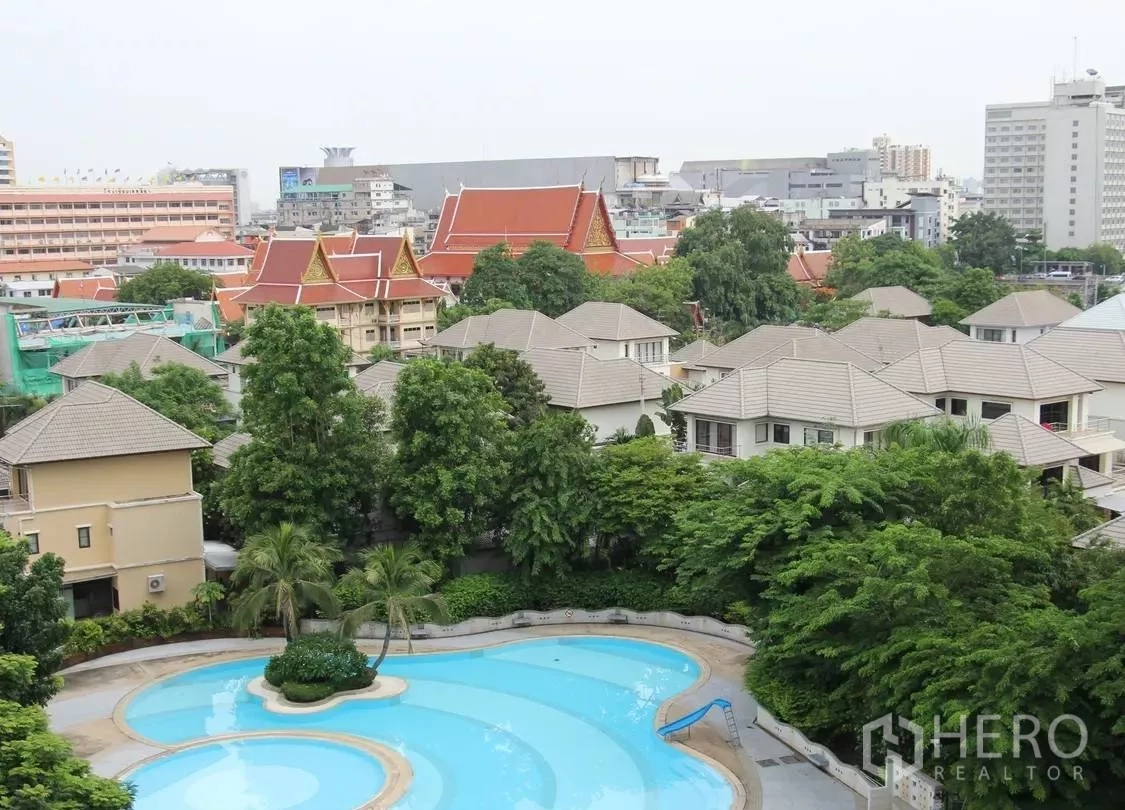 Condominium for sale in Wang Thonglang, Bangkok - Aerial view from the unit overlooking a freeform pool and leafy neighborhood.