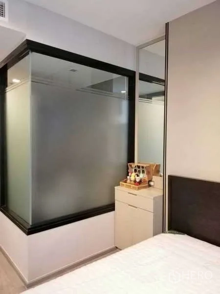 Condominium for rent or sale - Bedroom corner featuring a frosted glass partition and compact dressing table.
