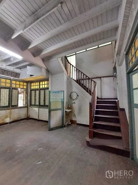 Detached House for rent in Bang Rak, Bangkok - Large entry hall with exposed rafters, wooden staircase, and patterned glass windows.