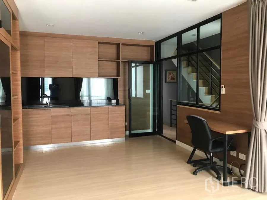 Home Office for rent or sale in Bang Phli, Samut Prakan - Built-in wood kitchen with black countertop, glass partition and desk in a home office.