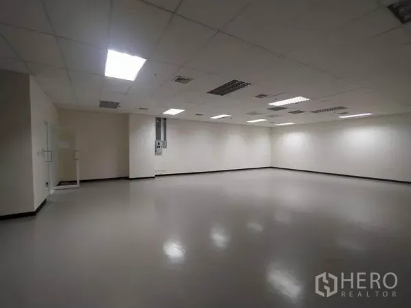 Office Space for rent in Bang Na, Bangkok - Spacious empty office interior with drop-ceiling lights and smooth flooring.
