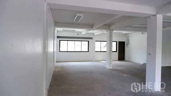 办公空间 出租在Watthana, Bangkok - 开放工作区，可见窗户、天花灯具和室内门。