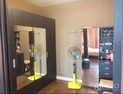 Detached House for sale in Khlong Sam Wa, Bangkok - Bedroom dressing area with large mirrored wardrobes and wood flooring.