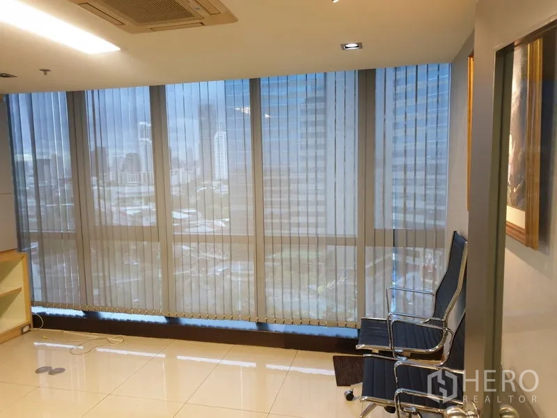 Office Space for rent - Floor-to-ceiling windows with vertical blinds offering Bangkok skyline views.