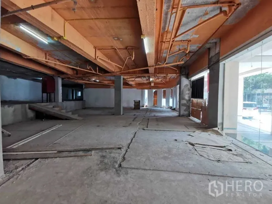 พื้นที่ขายปลีก ให้เช่าในKhlong Toei, Bangkok - ชั้นร้านค้ากว้าง มีหน้าต่างกระจกโชว์สินค้า ทางลาด และพื้นคอนกรีตดิบ