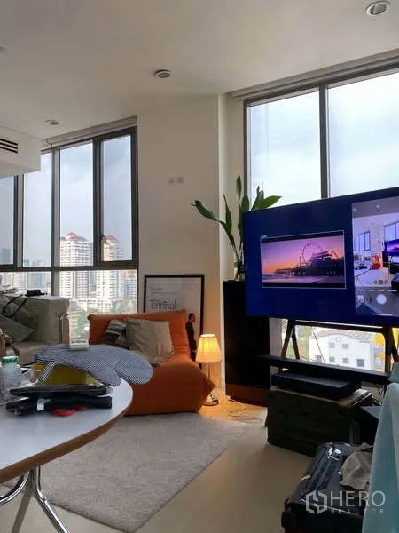 Condominium for rent - Corner living area with TV, accent chair and panoramic windows.
