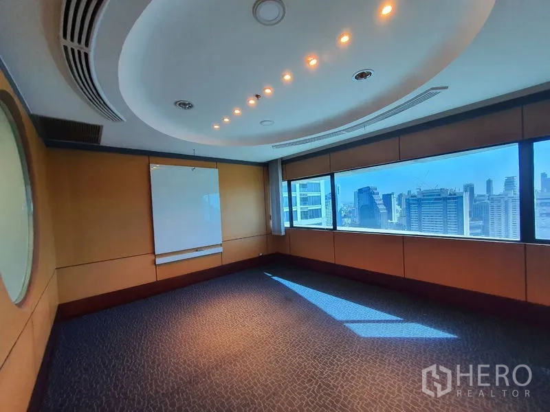 Office Space for rent in Watthana, Bangkok - Boardroom with an oval ceiling feature and long horizontal window facing the city.