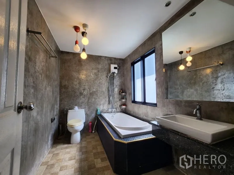 Home Office for sale - Spacious bathroom with bathtub, concrete-look walls, window and large mirror.