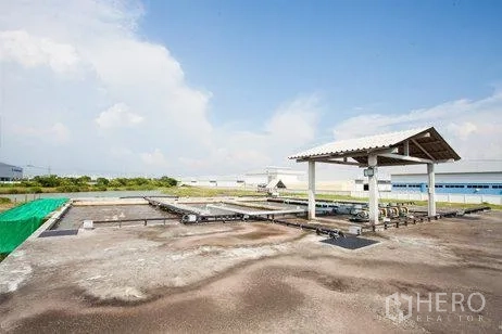 Factory for rent in Chachoengsao - Outdoor wastewater treatment basins with covered pump station inside a factory compound in Bang Pakong.