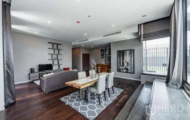 Condominium for rent - Open-plan lounge and dining space with high ceiling and expansive windows.