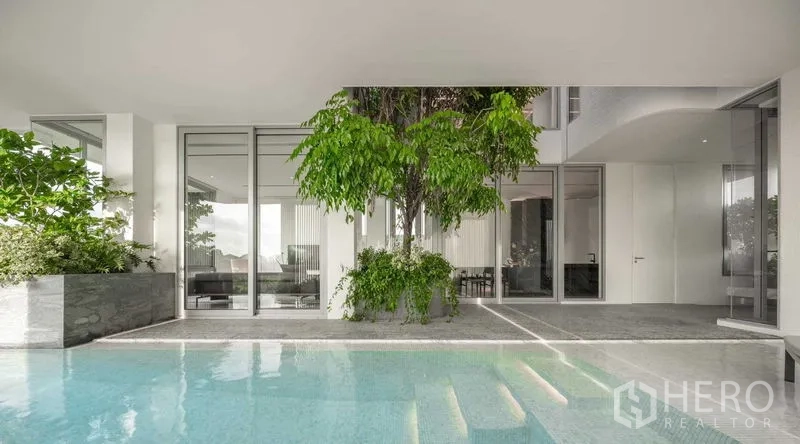Detached House for sale in Saphan Sung, Bangkok - Private swimming pool beside a covered terrace and tree planter.