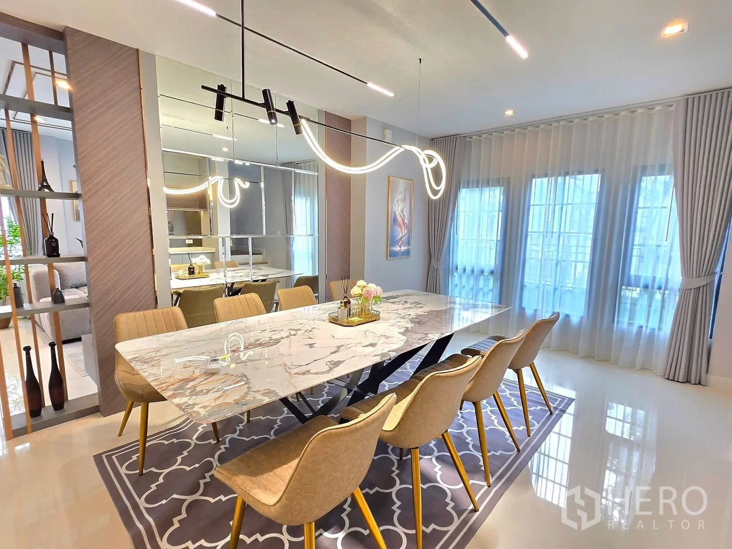 Detached House for rent in Bang Phli, Samut Prakan - Dining room with a marble table for eight and sculptural pendant lighting.